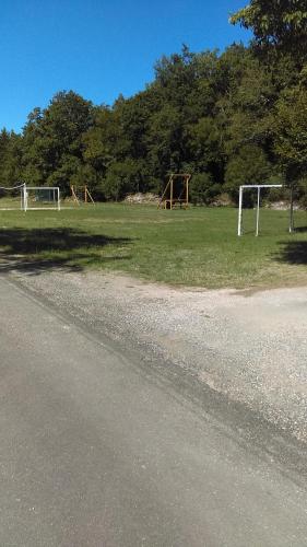 a field with two soccer goals in the grass at "Au Cha les Vaux" Chalet 49 in Mauroux