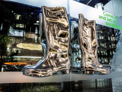 a pair of silver boots on display in a window at ibis Styles Manchester Portland in Manchester