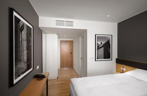 a bedroom with a bed and a black and white picture at Reykjavik Natura - Berjaya Iceland Hotels in Reykjavík