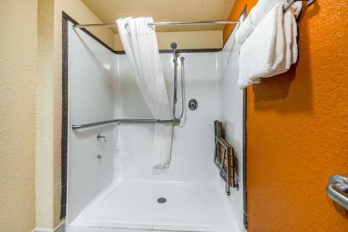a bathroom with a shower with a shower curtain at Sleep Inn & Suites Ocala - Belleview in Marion Oaks