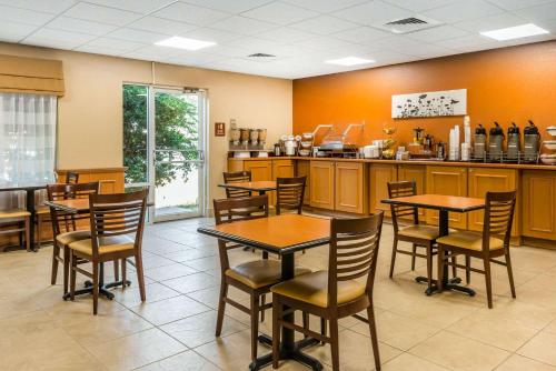 a restaurant with tables and chairs and a counter at Sleep Inn & Suites Ocala in Marion Oaks