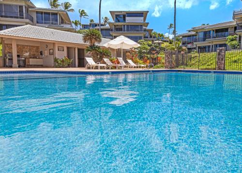 a large swimming pool with blue water in front of condos at Kapalua Bay Villa 29B4 villa in Kahana
