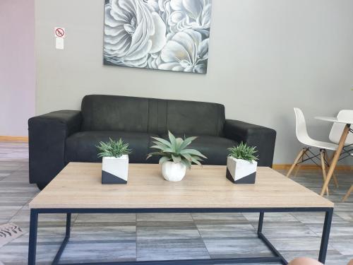 a coffee table in a living room with a couch at ikibiki in Beaufort West
