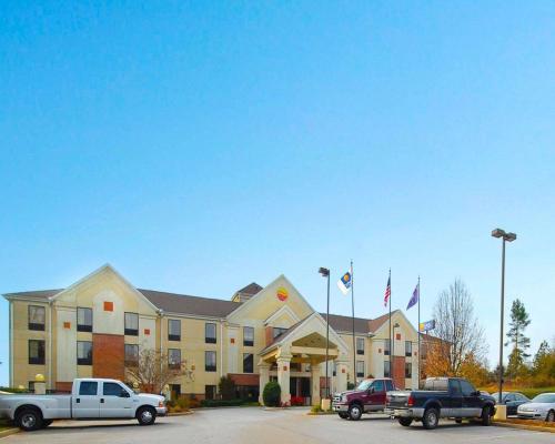 a hotel with cars parked in a parking lot at Comfort Inn & Suites at I-85 in Spartanburg