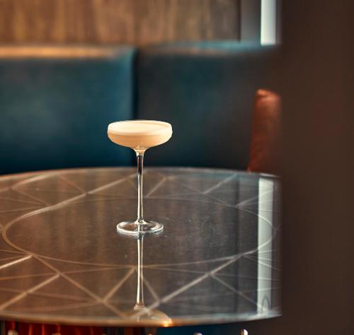 a wine glass sitting on top of a table at The Savoy in London