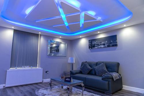 a living room with a couch and a blue ceiling at Meridian Serviced Apartments in Bradford