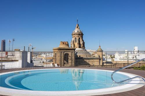 a swimming pool on the roof of a building at abba Sevilla in Seville