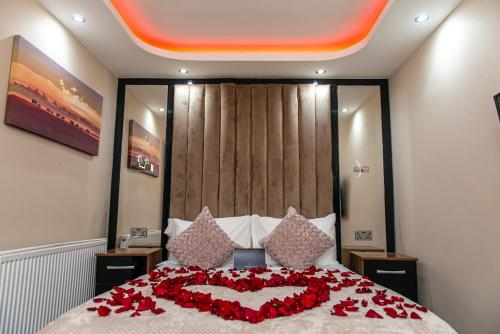 a bed with a heart made out of roses at Meridian Serviced Apartments in Bradford