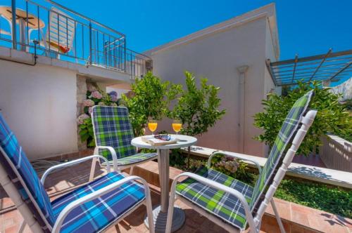 a patio with chairs and a table on a balcony at Villa Borna Apartments with Free Parking in Dubrovnik