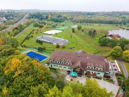 an aerial view of a house with a tennis court at Benedikt Most in Most