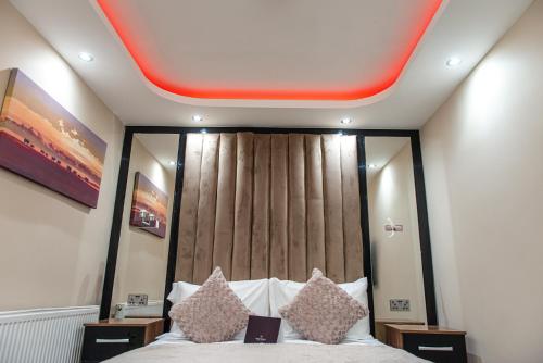 a bedroom with a bed with a red ceiling at Meridian Serviced Apartments in Bradford