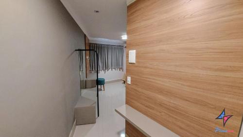 a hallway with a wooden wall in a house at Hotel PrimeInn in Campinas
