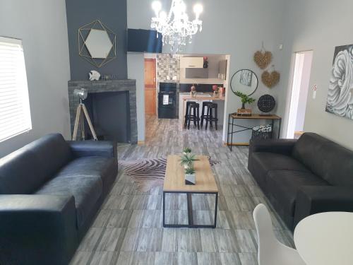 a living room with a couch and a table in it at ikibiki in Beaufort West