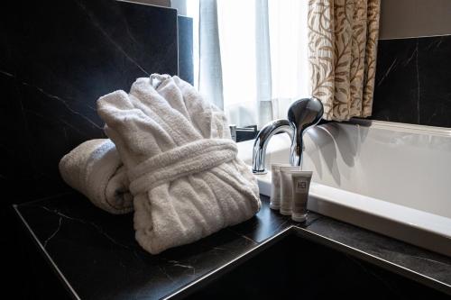 a white towel on a bathroom counter next to a sink at Hotel Master in Brescia