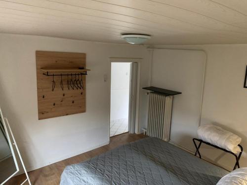 a bedroom with a bed and a painting on the wall at Hexenhäuschen Wankendorf in Wankendorf