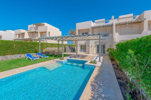 a villa with a swimming pool in front of a house at Joubal 3BR Villa Private Pool next to Marina in Hurghada
