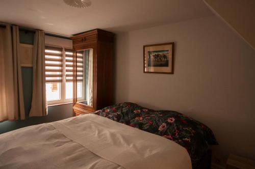 a bedroom with a bed and a window at Le bateau ivre in Fumay