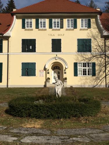 a building with a dog statue in front of it at Apartment 19 Vila Golf Nice Vacation in Rogaška Slatina