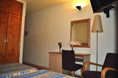 Ένα ή περισσότερα κρεβάτια σε δωμάτιο στο Hotel España