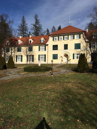 a large yellow building with a red roof at Apartment 19 Vila Golf Nice Vacation in Rogaška Slatina