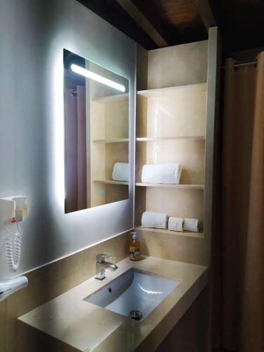 a bathroom with a sink and a mirror at ISA Granada in Granada