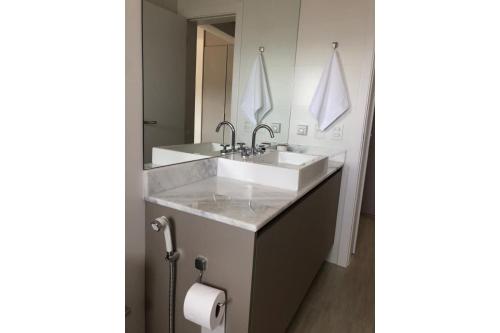a bathroom with a sink and a mirror at Atlântida Green Square - 606B in Xangri-lá
