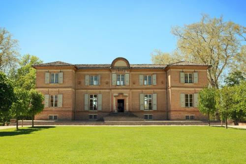 a large brick building with a lawn in front of it at Bauhaus Saint-Pierre in Gaillac