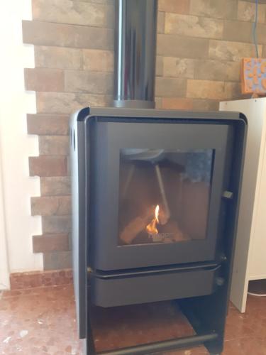 a fireplace in a brick wall with a fire in it at Casa Rural Plaza Zahara Buenas Vistas in Zahara de la Sierra