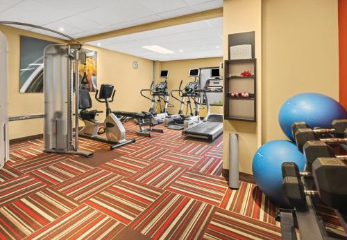 a fitness room with treadmills and exercise equipment at Super 8 by Wyndham Dallas Love Field Airport in Dallas