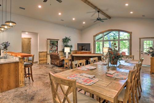 a dining room with a wooden table and chairs at Riverfront Heaven on the White with Covered Patio! in Norfork