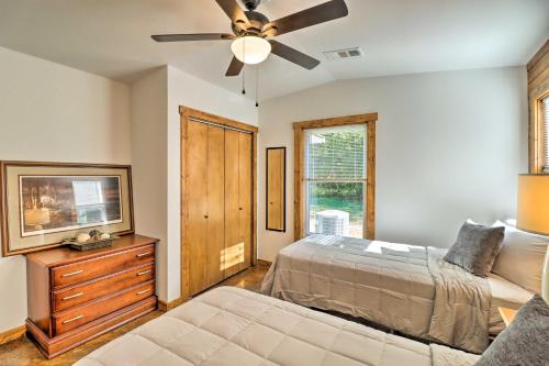 a bedroom with a bed and a ceiling fan at Riverfront Heaven on the White with Covered Patio! in Norfork