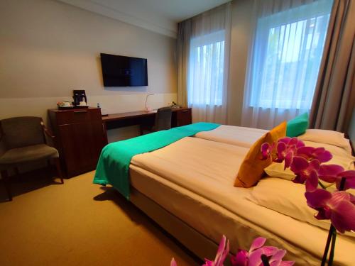 Łóżko lub łóżka w pokoju w obiekcie Hotel Zamek Centrum