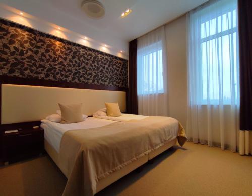 Ένα ή περισσότερα κρεβάτια σε δωμάτιο στο Hotel Zamek Centrum