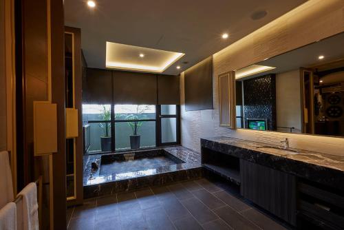 a bathroom with a sink and a large window at Motel Lin in Taichung