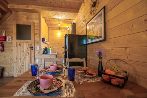 a dining room with a table with plates of food at Z Bieszcza Rodem in Ustrzyki Dolne