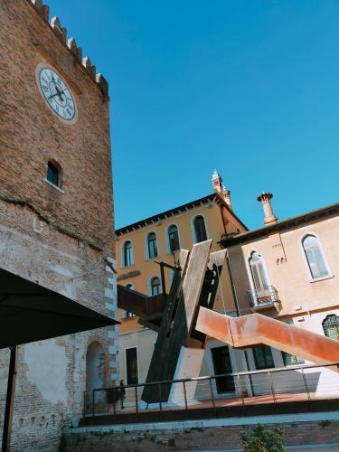 a clock tower next to a building with a statue at Ca' Palazzo in Mestre