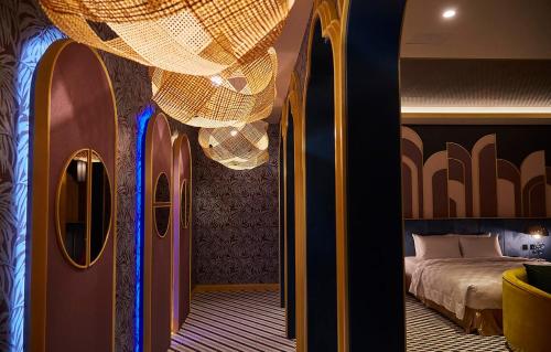 a bedroom with a bed and a chandelier at Motel Lin in Taichung