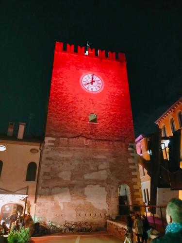 a clock tower with a red light on it at Ca' Palazzo in Mestre