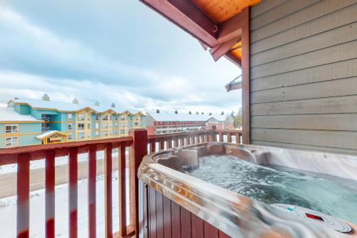 a hot tub on the balcony of a house at Bears Paw 5 in Big White