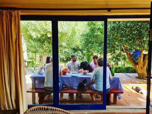 a group of people sitting at a picnic table at Out of Town in Castelo de Paiva