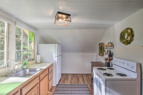 a kitchen with a white refrigerator and a sink at Owls Nest Studio with Hot Tub Hike Nearby! in Ashford