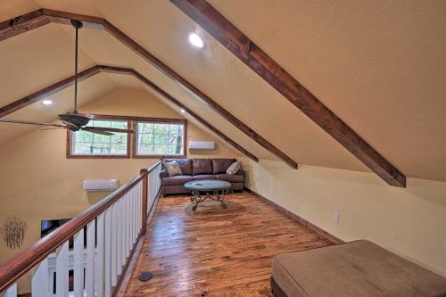 a living room with a couch and a table at Tudor-Style Broken Bow Cottage with Hot Tub and Decks! in Stephens Gap