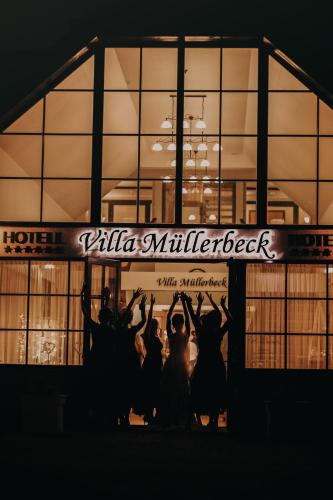 a group of people standing in front of a building at Villa Müllerbeck in Otepää