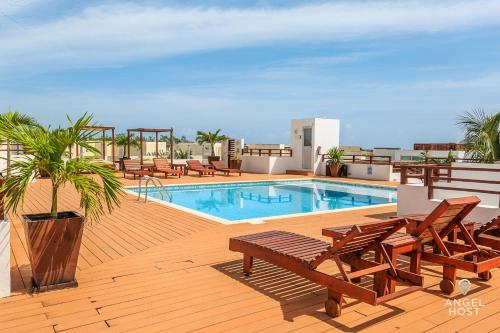 a swimming pool on top of a building with a deck at Casa del Mar by Stella Rentals in Playa del Carmen