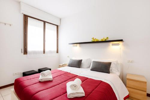 a bedroom with a large bed with two towels on it at Firenze Nova Comfortable Apartament with Terrace in Florence