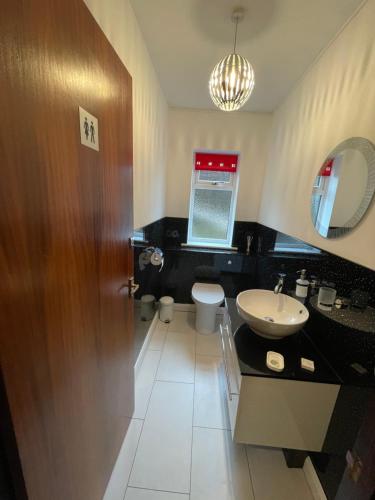 a bathroom with a sink and a toilet at Heathwood in Dover