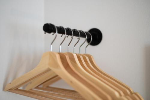 a wooden rack with hangers on a wall at Contractor Base - 4 Beds - Dining - Wi-Fi in Swansea