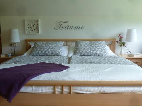a bedroom with a large bed with a purple blanket at Villa Schnuck - das rote Ferienhaus in Bad Gastein