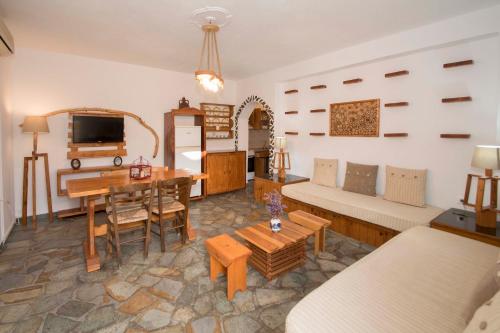 a living room with a couch and a table at Papafragas Studios in Pachaina