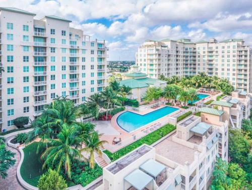 an aerial view of a resort with a pool and buildings at Tropical Coastal Resort Boynton Beach in Boynton Beach
